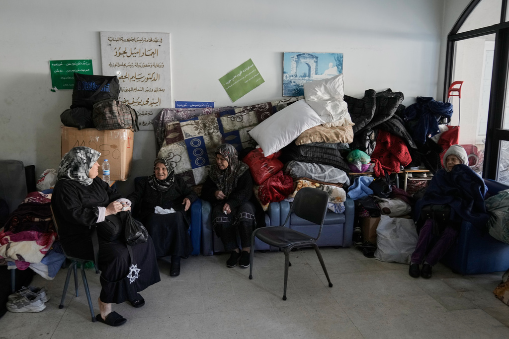 Displaced people fleeing Israeli airstrikes in southern Lebanon and Dahiyeh, Beirut's southern suburbs, settle at the Bir Hassan Technical Institute, which has been turned into a shelter, in Beirut, Lebanon, Wednesday, March 11, 2026. (AP Photo/Bilal Hussein)