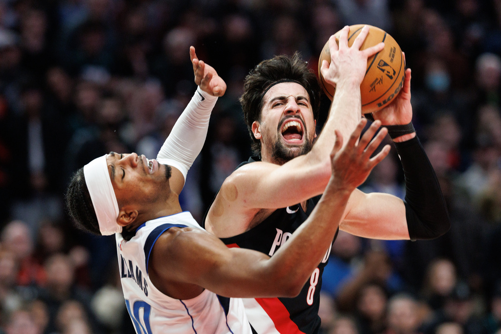 Portland Trail Blazers forward Deni Avdija, right, drives to the basket against Dallas Mavericks guard Brandon Williams, left, during the second half of an NBA basketball game Monday Dec. 29, 2025, in Portland, Ore. (AP Photo/Howard Lao)