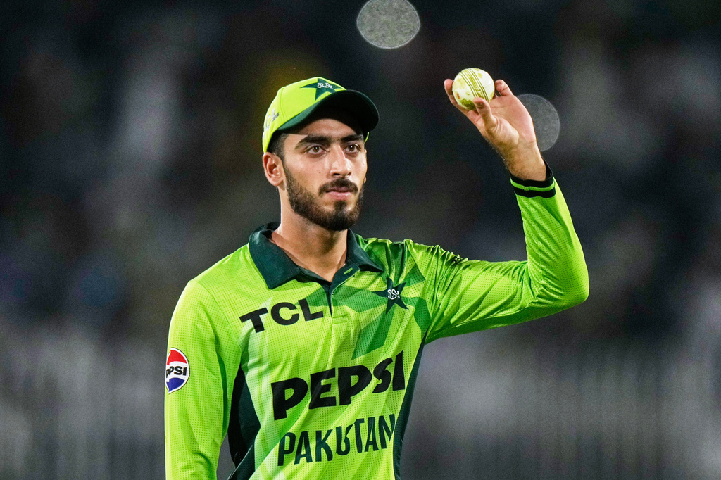 Pakistan's Arafat Minhas, who took five wickets, displays the ball as he walks off the field on the end of first innings during the first one day international cricket match between Pakistan and Australia, in Rawalpindi, Pakistan, Saturday, May 30, 2026. (AP Photo/Anjum Naveed)