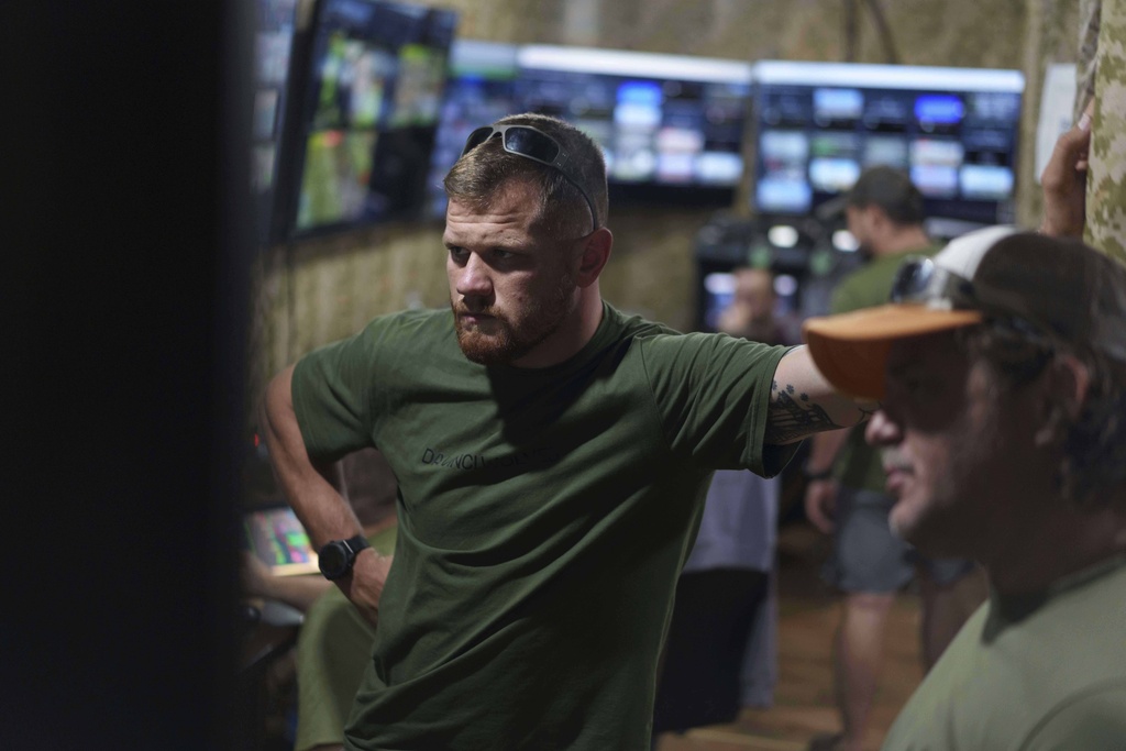 Serhii Filimonov, commander of the Da Vinci Wolves Battalion looks on a live stream from the frontline during fighting with Russian on Pokrovsk direction, Ukraine, Saturday, Aug. 9, 2025. (AP Photo/Evgeniy Maloletka)