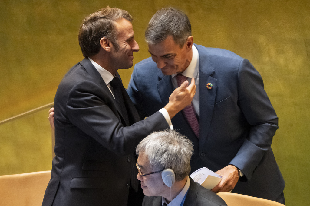 France's President Emmanuel Macron and Spain's Prime Minister Pedro Sanchez embrace each other during a high-profile meeting at the United Nations aimed at galvanizing support for a two-state solution to the Israeli-Palestinian conflict, Monday, Sept. 22, 2025, at U.N. headquarters. (AP Photo/Yuki Iwamura)