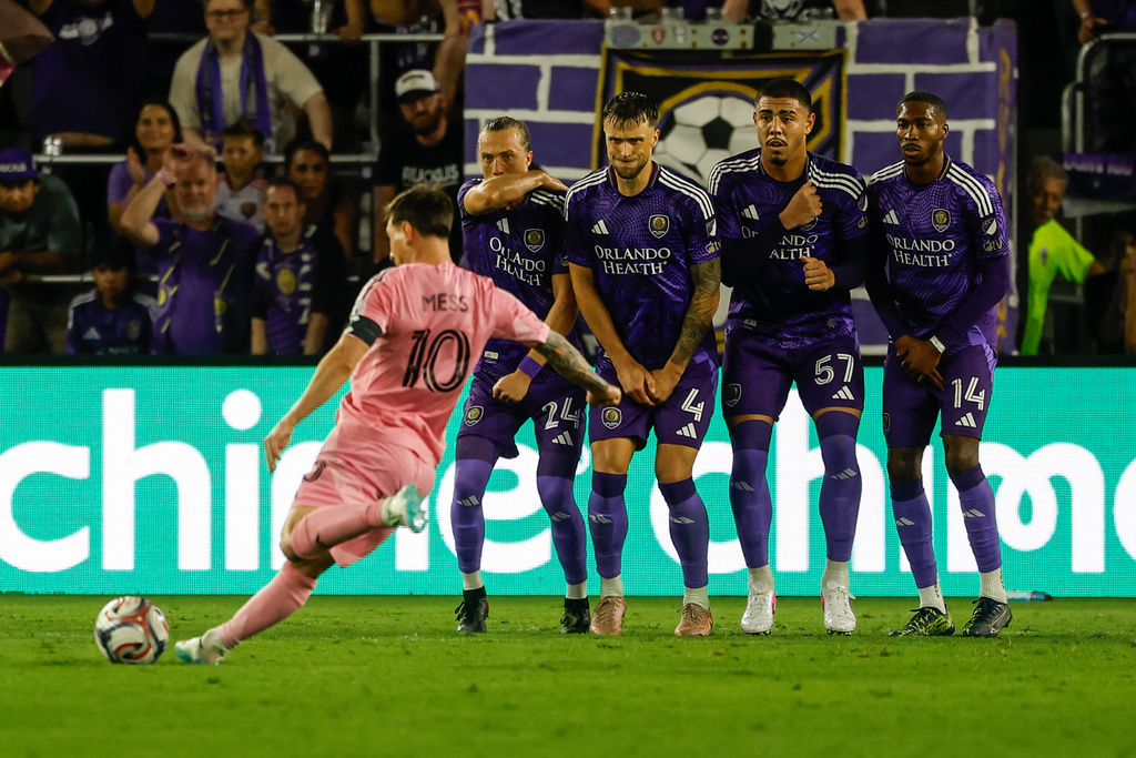 Inter Miami CF forward Lionel Messi (10) takes his penalty kick around Orlando City SC blockers during the second half of an MLS soccer match, Sunday, March 1, 2026, in Orlando, Fla. (AP Photo/Kevin Kolczynski)