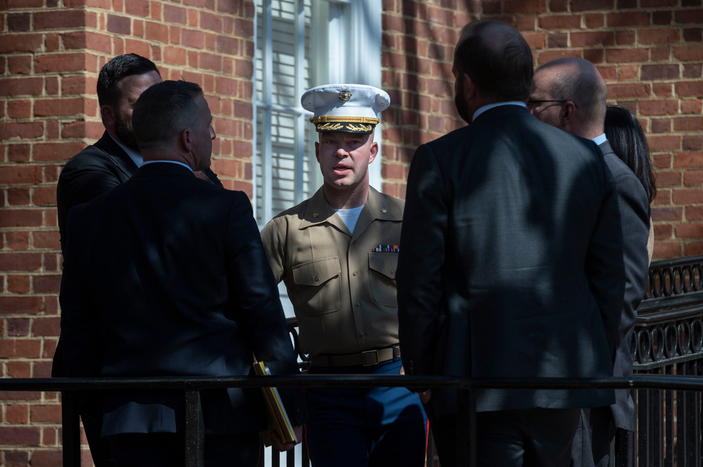 FILE - U.S. Marine Corp Major Joshua Mast, center, talks with his attorneys during a break in the hearing of an ongoing custody battle over an Afghan orphan, March 30, 2023, at the Circuit Courthouse in Charlottesville, Va. (AP Photo/Cliff Owen, File)