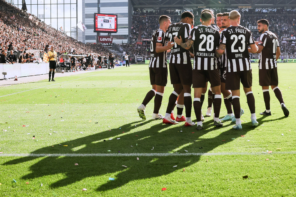 St. Pauli's players celebrate their side's first goal during the German Bundesliga soccer match between 1. FC St. Pauli and FC Augsburg in Hamburg, Germany, Sunday, Sept. 14, 2025. (Christian Charisius/dpa via AP)