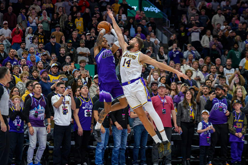 Utah Jazz guard Keyonte George (3) takes the final shot of the game defended by Los Angeles Lakers forward Maxi Kleber (14) as the Jazz attempted to tie the game and send to overtime during the second half of an NBA basketball game, Sunday, Nov. 23, 2025, in Salt Lake City. (AP Photo/Tyler Tate)