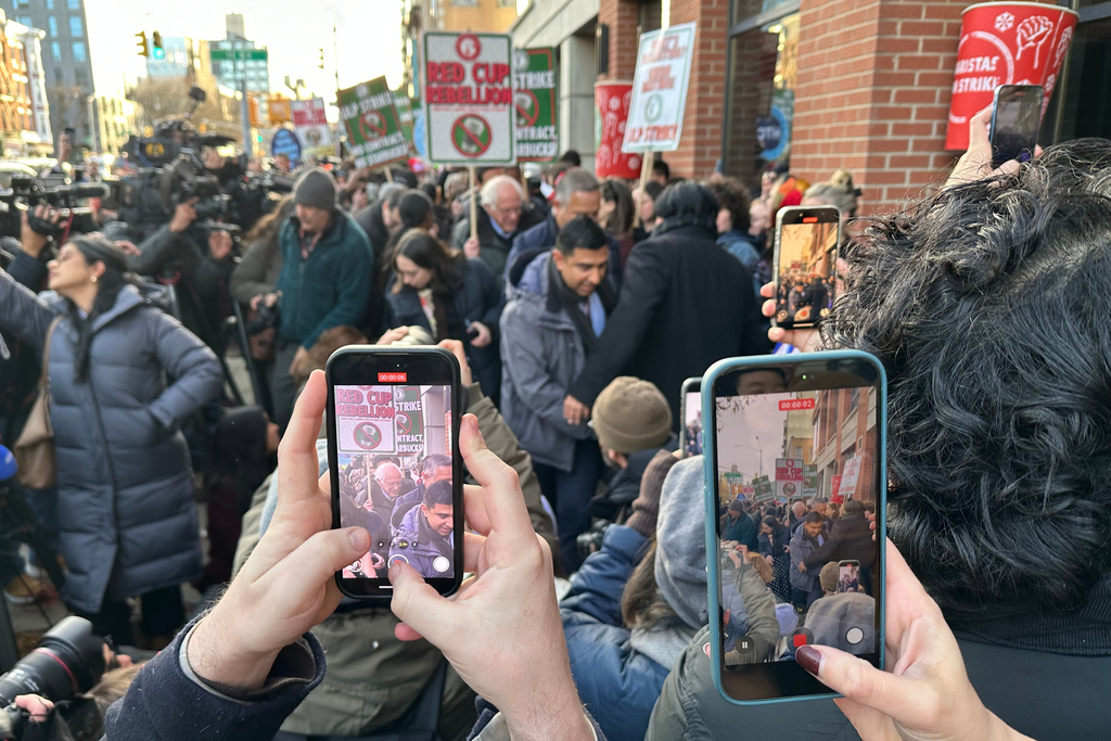 U.S. Sen. Bernie Sanders, I-Vt., visits striking Starbucks workers and supporters outside a Starbucks store in Brooklyn, New York, Monday, Dec. 1, 2025. (AP Photo/Jennifer Peltz)