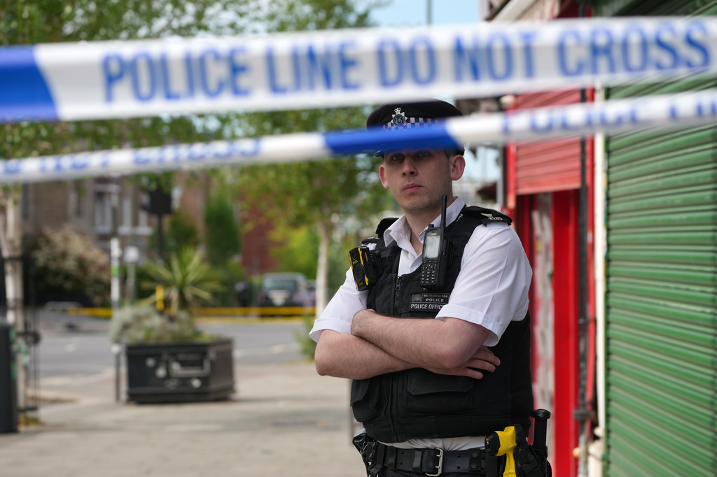A police officer stands behind a police cordon after two people were stabbed in Golders Green neighbourhood, that has a large Jewish community, in London, Wednesday, April 29, 2026.(AP Photo/Kin Cheung)