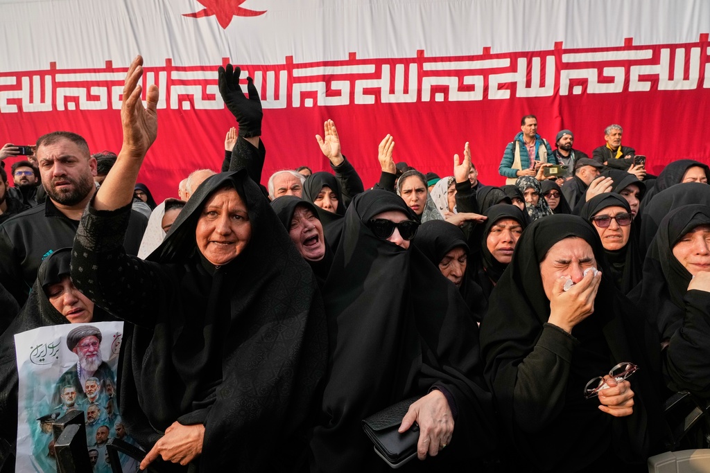 Mourners react during the funeral ceremony for Gen. Ali Shamkhani, secretary of Iran's Defense Council and a senior adviser to the Supreme Leader who was killed in a strike, at the courtyard of the Imamzadeh Saleh shrine in Tehran, Iran, Saturday, March 14, 2026. (AP Photo/Vahid Salemi)