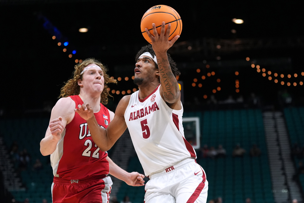 Alabama forward Amari Allen (5) drives past UNLV forward Walter Brown (22) during the first half of an NCAA college basketball game in the Players Era tournament Las Vegas, Tuesday, Nov. 25, 2025. (AP Photo/Eric Gay)