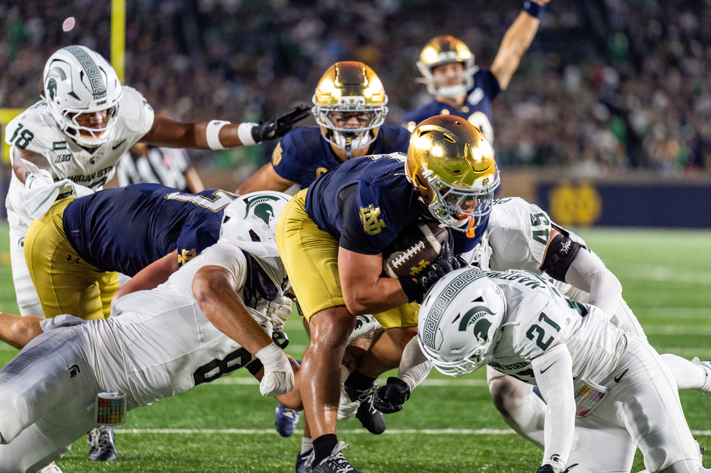 Notre Dame running back Nolan James Jr. (2) scores a touchdown during the first half of a college football game against Michigan State, Saturday, Sept. 19, 2026, in South Bend, Ind. (AP Photo/Paul Barnick) CORRECTION: corrects name and position of player to running back Nolan James Jr., not cornerback DJ McKinney