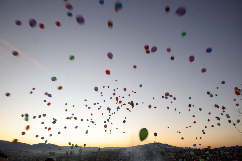 Balloons released by children float into the sky to mark the beginning of the holy month of Ramadan in Sarajevo, Bosnia, Wednesday, Feb. 18, 2026. (AP Photo/Armin Durgut)