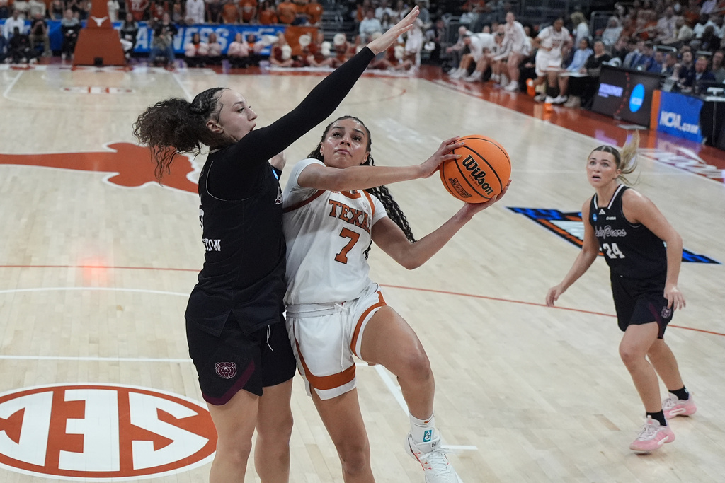 Texas guard Jordan Lee (7) drives to the basket against Missouri State forward Maiesha Washington, left, during the first half in the first round of the NCAA college basketball tournament game, Friday, March 20, 2026. (AP Photo/Eric Gay)