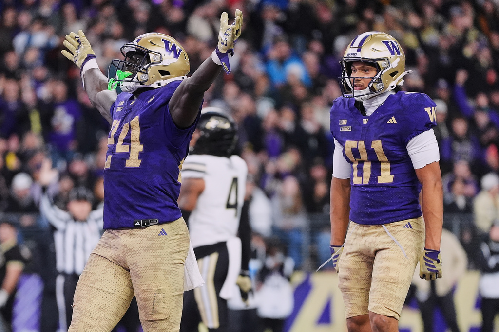 Washington running back Adam Mohammed (24) celebrates his touchdown against Purdue with wide receiver Dezmen Roebuck (81) during the first half of an NCAA college football game, Saturday, Nov. 15, 2025, in Seattle. (AP Photo/Lindsey Wasson)