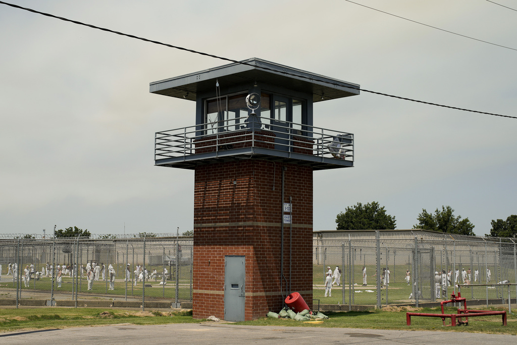 FILE - Prisoners walk through a yard at the Varner Unit of Arkansas' Department of Corrections, Friday, Aug. 18, 2023, in Gould, Ark. (AP Photo/John Locher, File)