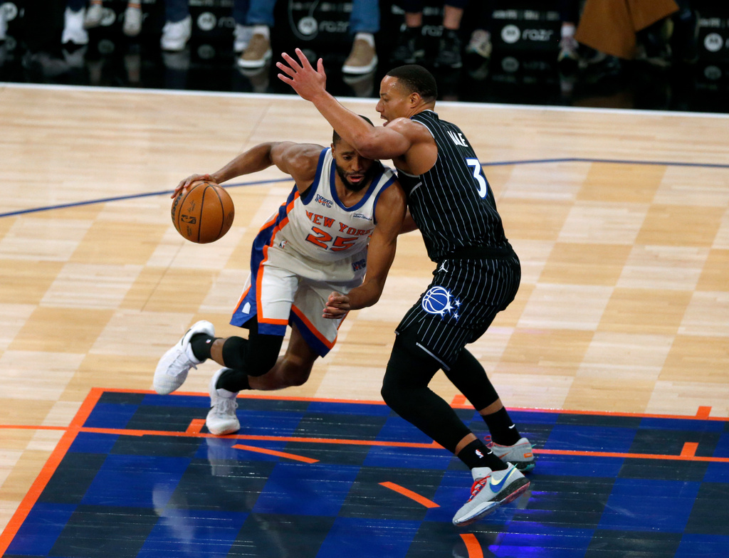 New York Knicks guard Mikal Bridges, left, dribbles around Orlando Magic guard Desmond Bane during the first half of an NBA basketball game Sunday, Dec. 7, 2025, in New York. (AP Photo/John Munson)