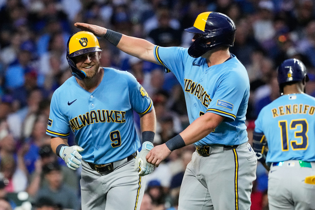 Milwaukee Brewers' Jake Bauers, left, is congratulated by Andrew Vaughn after hitting a three-run home run during the fifth inning of a baseball game against the Chicago Cubs in Chicago, Monday, May 18, 2026. (AP Photo/Nam Y. Huh)