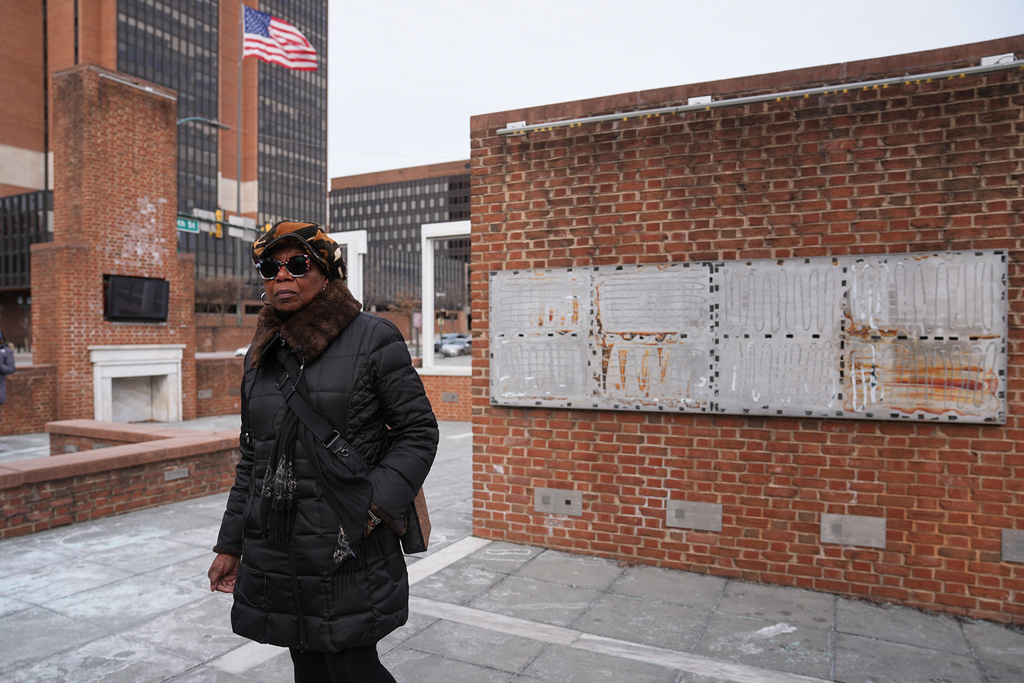 Karen Oliver walks by the locations of a now removed explanatory panels that were part of an exhibit on slavery at President's House Site in Philadelphia, Friday, Jan. 23, 2026. (AP Photo/Matt Rourke)
