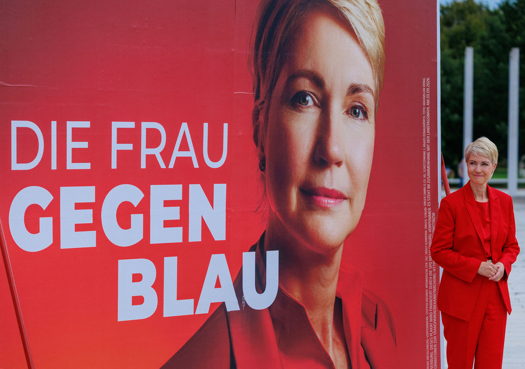 Social Democratic Party Prime Minister of Mecklenburg-Western Pomerania and the party's top candidate for the upcoming state election Manuela Schwesig poses in front of an election campaign poster reading "The Woman Against Blue", in Schwerin, Germany, Monday, Sept. 7, 2026. ( Jens Buettner/dpa via AP)