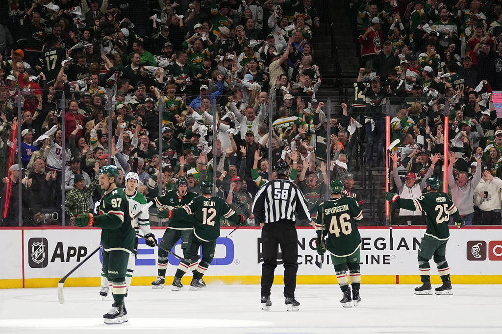 Minnesota Wild center Michael McCarron (47), back, left, celebrates after scoring a goal during the second period of Game 3 in the first round of the NHL Stanley Cup hockey playoffs against the Dallas Stars Wednesday, April 22, 2026, in St. Paul, Minn. (AP Photo/Abbie Parr)