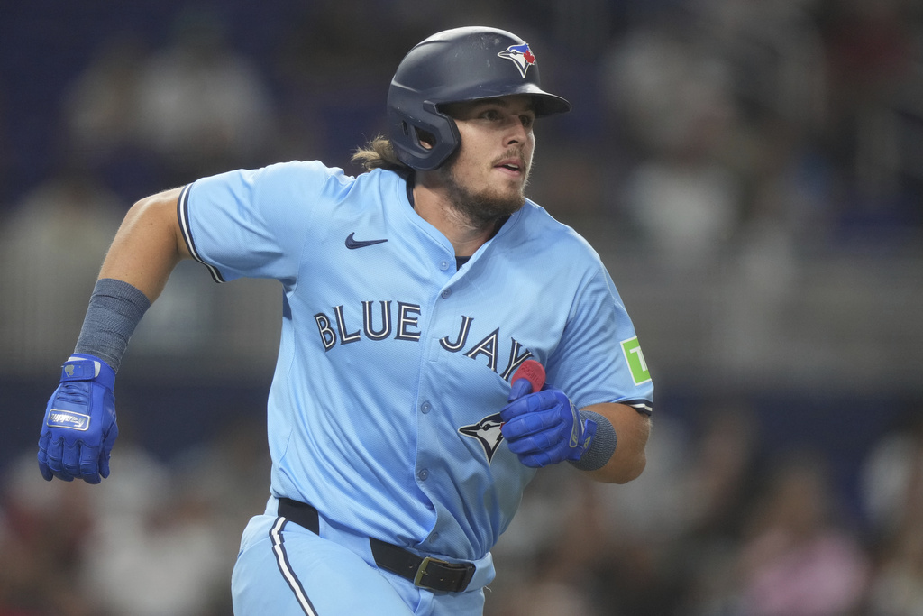Toronto Blue Jays' Addison Barger runs after hitting a base hit during the third inning of a baseball game against the Miami Marlins, Friday, Aug. 22, 2025, in Miami. (AP Photo/Marta Lavandier)