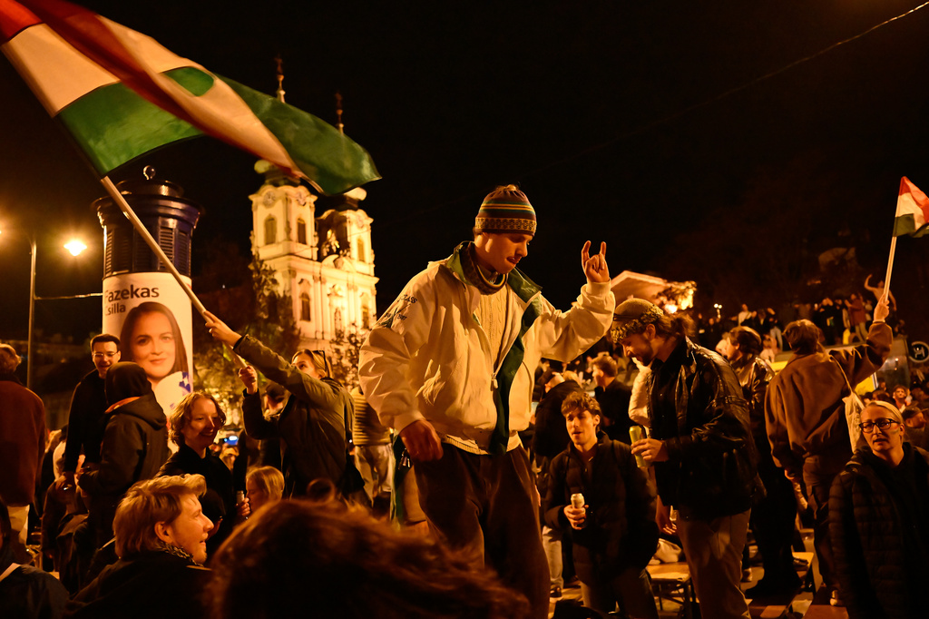 Youngsters celebrate in Budapest, Hungary, Monday, April 13, 2026, after Peter Magyar's Tisza party defeated Prime Minister Viktor Orban's Fidesz party in the country's parliamentary elections. (AP Photo/Denes Erdos)
