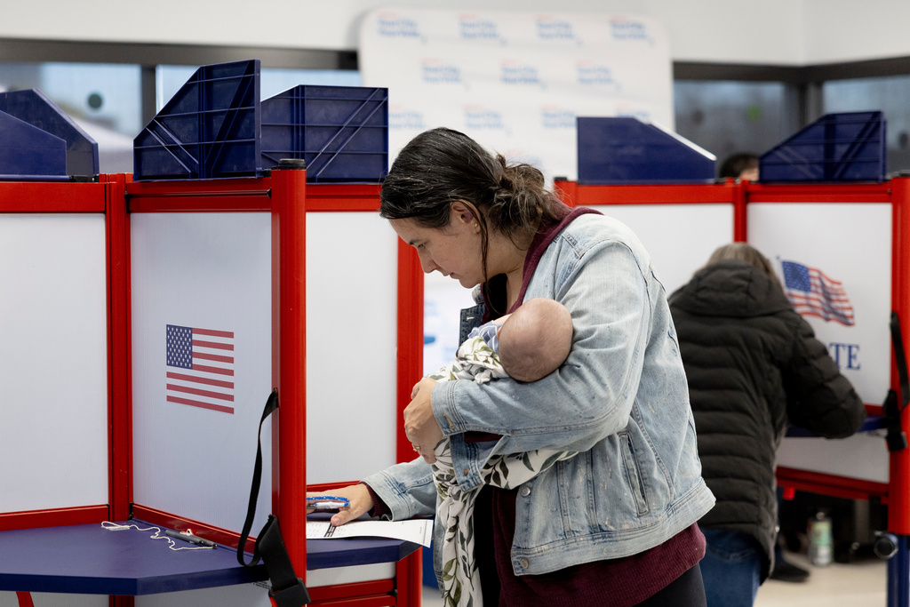 Aldona Martinka carries her 2-month-old daughter while voting at Minneapolis Elections and Voter Services ahead of Election Day, Monday, Nov. 3, 2025, in Minneapolis. (Ellen Schmidt/MinnPost via AP)