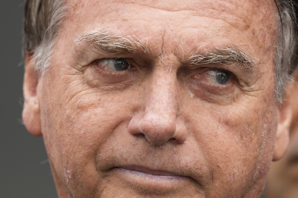 Former President Jair Bolsonaro, temporarily allowed out of house arrest for medical treatment, departs a hospital in Brasilia, Brazil, Sunday, Sep. 14, 2025. (AP Photo/Eraldo Peres)