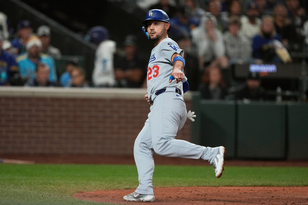 Los Angeles Dodgers' Michael Conforto gestures after scoring off a wild pitch by Seattle Mariners relief pitcher Logan Evans during the seventh inning of a baseball game, Saturday, Sept. 27, 2025, in Seattle. (AP Photo/Ryan Sun)