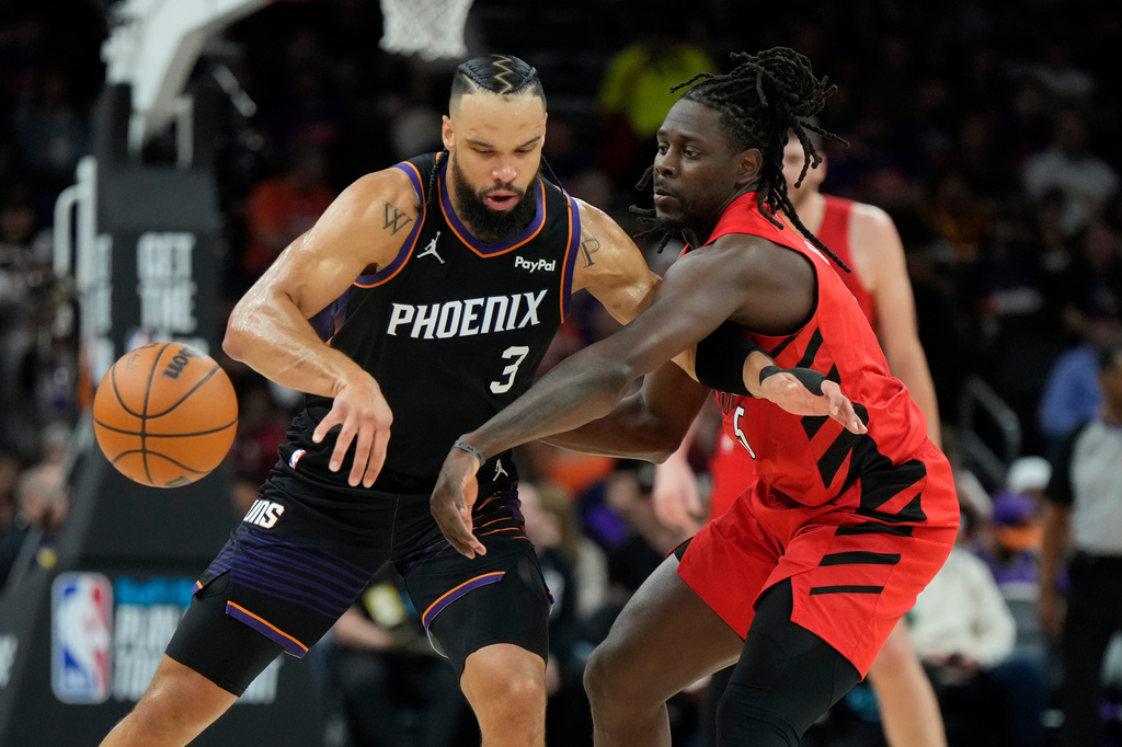 Portland Trail Blazers guard Jrue Holiday (5) tips the ball away from Phoenix Suns forward Dillon Brooks (3) during the first half of an NBA play-in tournament basketball game, Tuesday, April 14, 2026, in Phoenix. (AP Photo/Ross D. Franklin)
