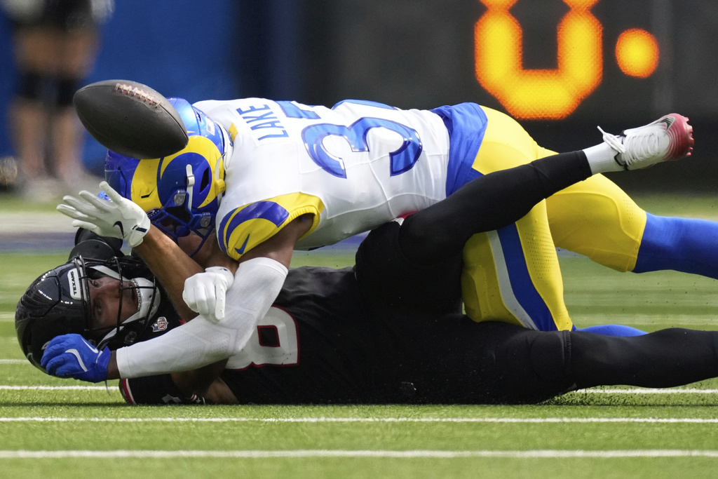 Houston Texans wide receiver Justin Watson, bottom, cannot catch a pass against Los Angeles Rams safety Quentin Lake during the first half of an NFL football game, Sunday, Sept. 7, 2025, in Inglewood, Calif. (AP Photo/Mark J. Terrill)