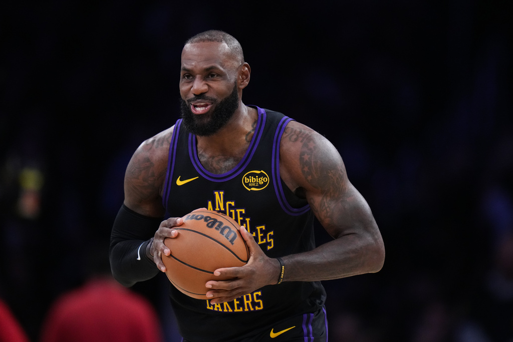 Los Angeles Lakers forward LeBron James (23) holds the ball before the tip-off during the first half of an NBA basketball game against the Utah Jazz Tuesday, Nov. 18, 2025, in Los Angeles. (AP Photo/Jae C. Hong)