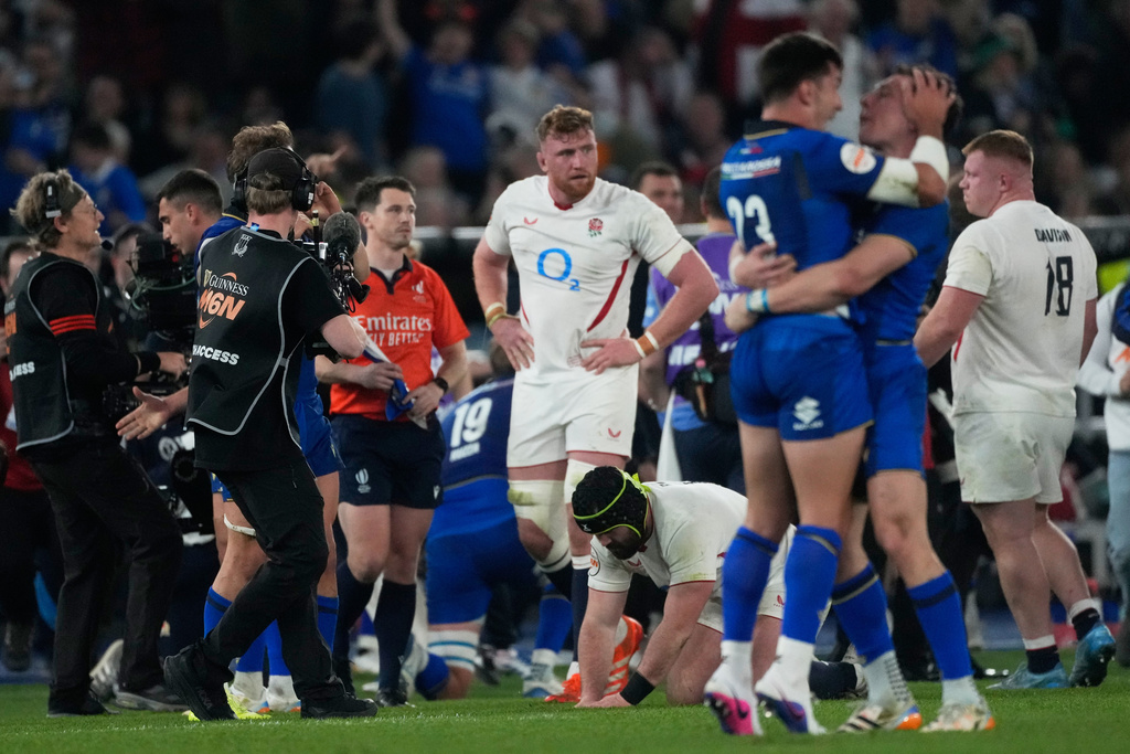 England's players stand on the pitch at the end of the Six Nations rugby union match between Italy and England in Rome, Saturday, March 7, 2026. (AP Photo/Gregorio Borgia)