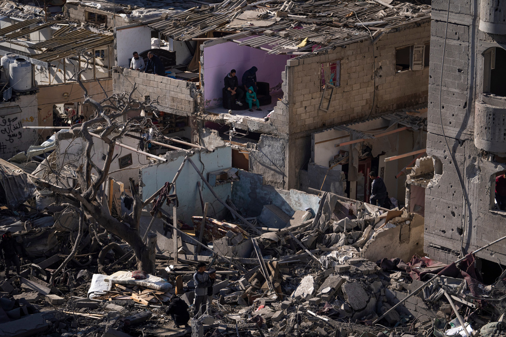 People look at the destruction after an Israeli strike on residential buildings and a mosque in Rafah, Gaza Strip, Thursday, Feb. 22, 2024. (AP Photo/Fatima Shbair)