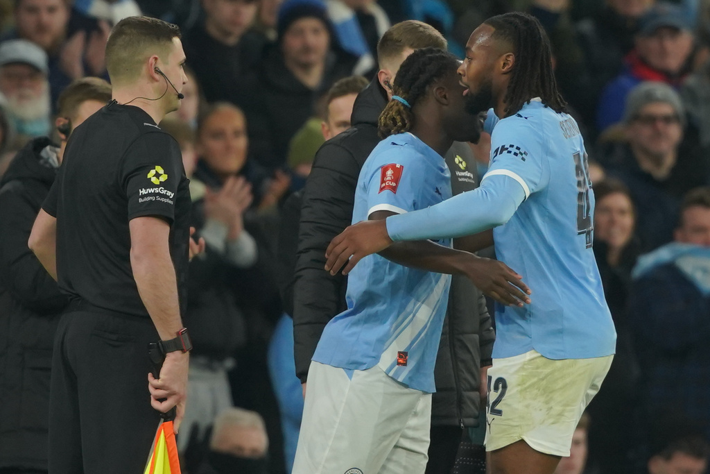 Manchester City's Jeremy Doku substitutes Antoine Semenyo during the FA Cup third round match between Manchetster City and Exeter City in Manchester, England Saturday, Jan. 10, 2026. (AP Photo/Ian Hodgson)