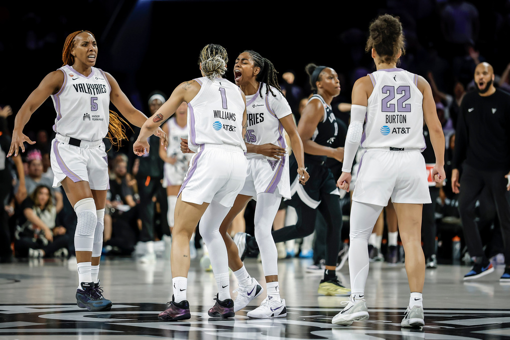 Golden State Valkyries players gather to celebrate teammate Gabby Williams's (1) 2-point basket in the final seconds of overtime as the team defeated the Las Vegas Aces in Game 3 of the WNBA basketball semifinals Friday, Oct. 9, 2026, in Las Vegas. (Carlos Avila Gonzalez/San Francisco Chronicle via AP)