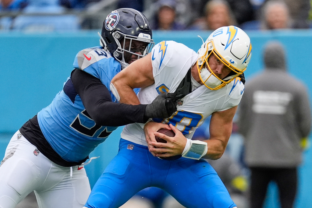Los Angeles Chargers quarterback Justin Herbert (10) is sacked by Tennessee Titans linebacker Jihad Ward (53) during the second half of an NFL football game Sunday, Nov. 2, 2025, in Nashville, Tenn. (AP Photo/George Walker IV)