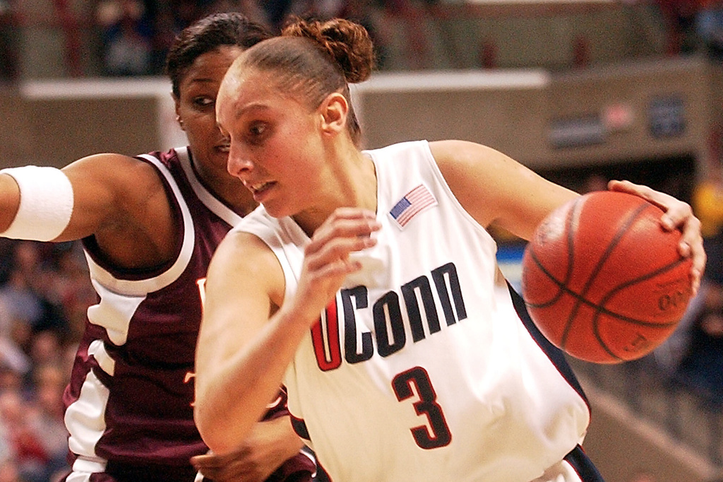 FILE - Connecticut's Diana Taurasi pushes past Virginia Tech's Chrystal Starling during the second half of an NCAA college basketball game at Storrs, Conn., Sunday, Jan. 12, 2003. (AP Photo/Bob Child, File)