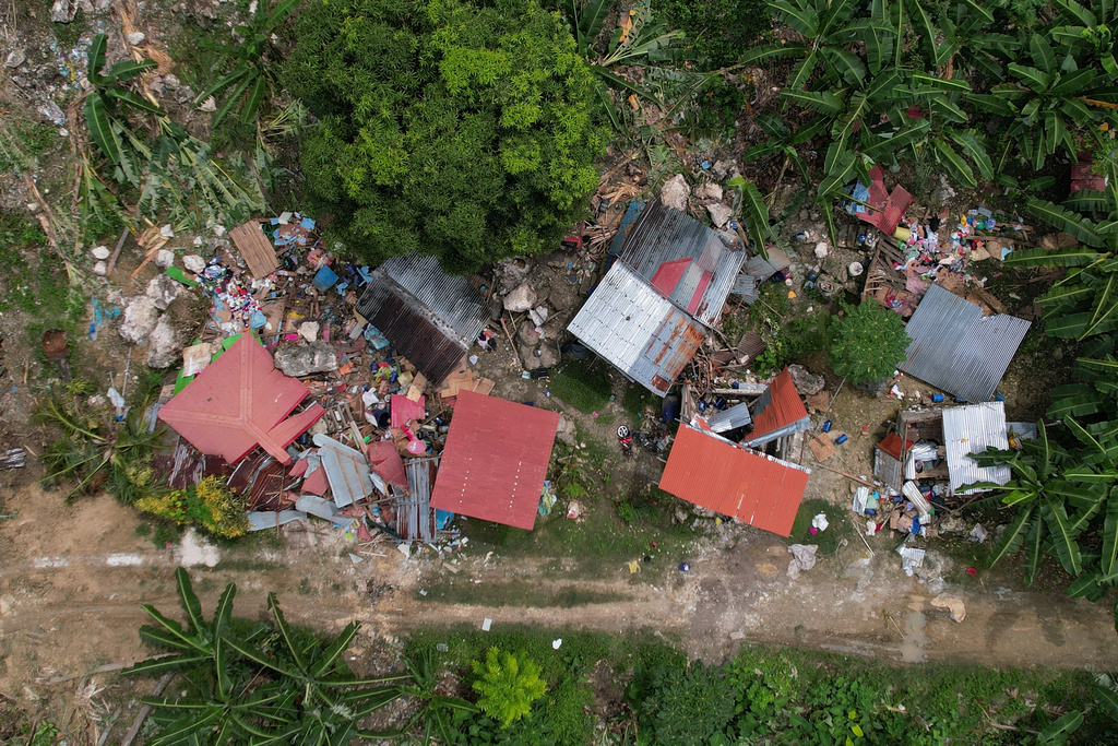 Damaged homes lie after a landslide caused by Tuesday's strong earthquake killed some people sleeping in their hillside homes, Thursday, Oct. 2, 2025, in Bogo city, Cebu Province, Central Philippines. (AP Photo/Aaron Favila)