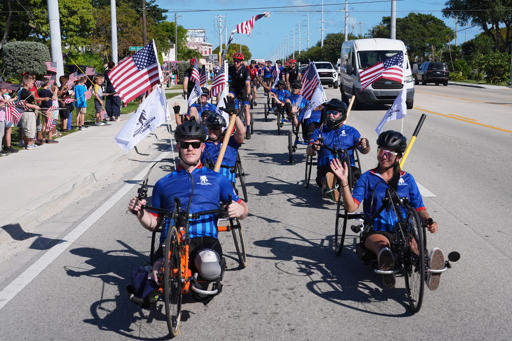 People line the street as wounded veterans ride in the annual Florida Keys Soldier Ride organized by the Wounded Warrior Project, Friday, Jan. 9, 2026, in Marathon, Fla. (AP Photo/Lynne Sladky)