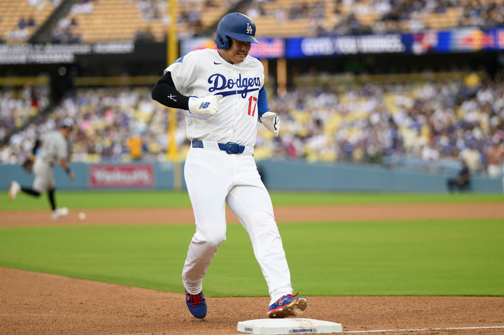 Los Angeles Dodgers' Shohei Ohtani runs to third base during the third inning of a baseball game against the Arizona Diamondbacks in Los Angeles, Sunday, July 12, 2026. (AP Photo/Kyusung Gong)