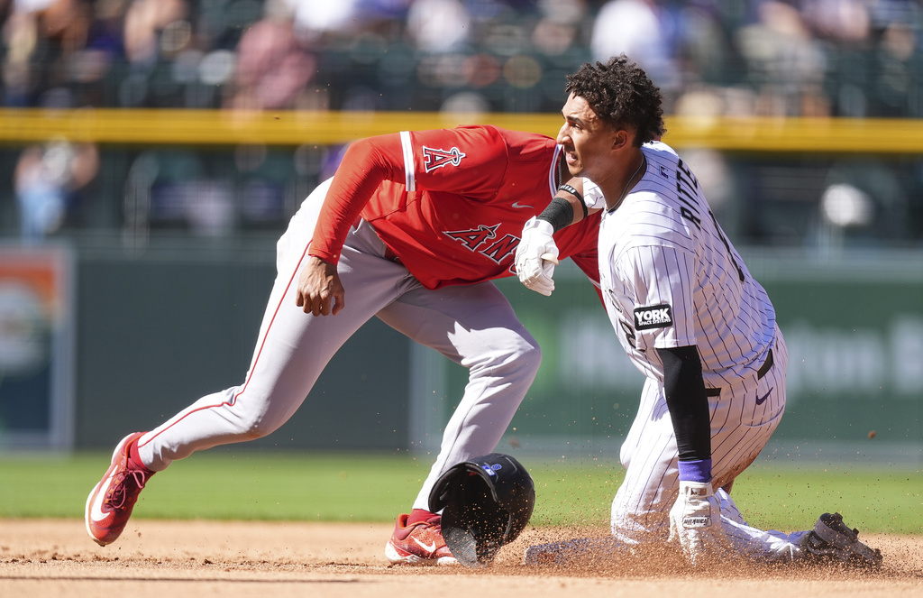 Los Angeles Angels second baseman Christian Moore, left, tags out Colorado Rockies' Ryan Ritter, right, who was trying to steal second in the fifth inning of a baseball game Sunday, Sept. 21, 2025, in Denver. (AP Photo/David Zalubowski)