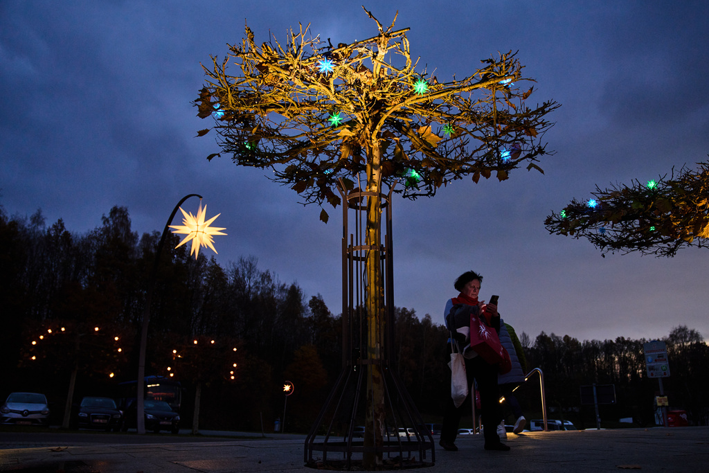 People visit Herrnhuter Sterne GmbH manufacturing, a Christmas stars manufacturing company in Herrnhut, Germany, Nov. 10, 2025. (AP Photo/Ebrahim Noroozi)