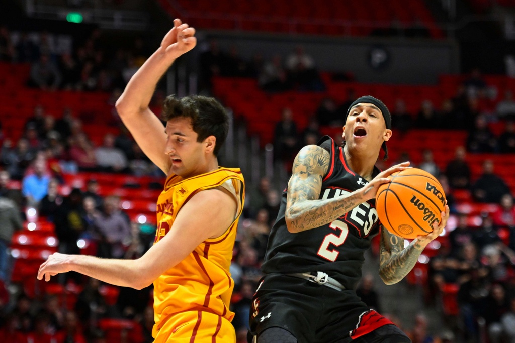 Utah guard Terrence Brown (2) shoots over Iowa State forward Milan Momcilovic, left, during the first half of an NCAA college basketball game, Tuesday, Feb. 24, 2026, in Salt Lake City. (AP Photo/Alex Goodlett)