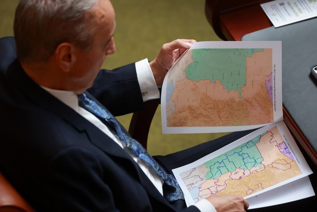 FILE -Rep. Cory Maloy, R-Lehi, holds a packet of potential redistricting maps as SB1012 Congressional Boundaries Designation is discussed in the House chamber during a special session at the Capitol on Monday, Oct. 6, 2025, in Salt Lake City. (Kristin Murphy/The Deseret News via AP, File)