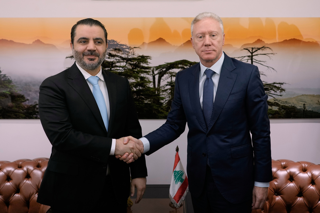 Lebanese Foreign Minister Youssef Rajji, right, shakes hands with his Syrian counterpart Asaad al-Shibani before their meeting in Beirut, Lebanon, Friday, Oct. 10, 2025. (AP Photo/Hassan Ammar)