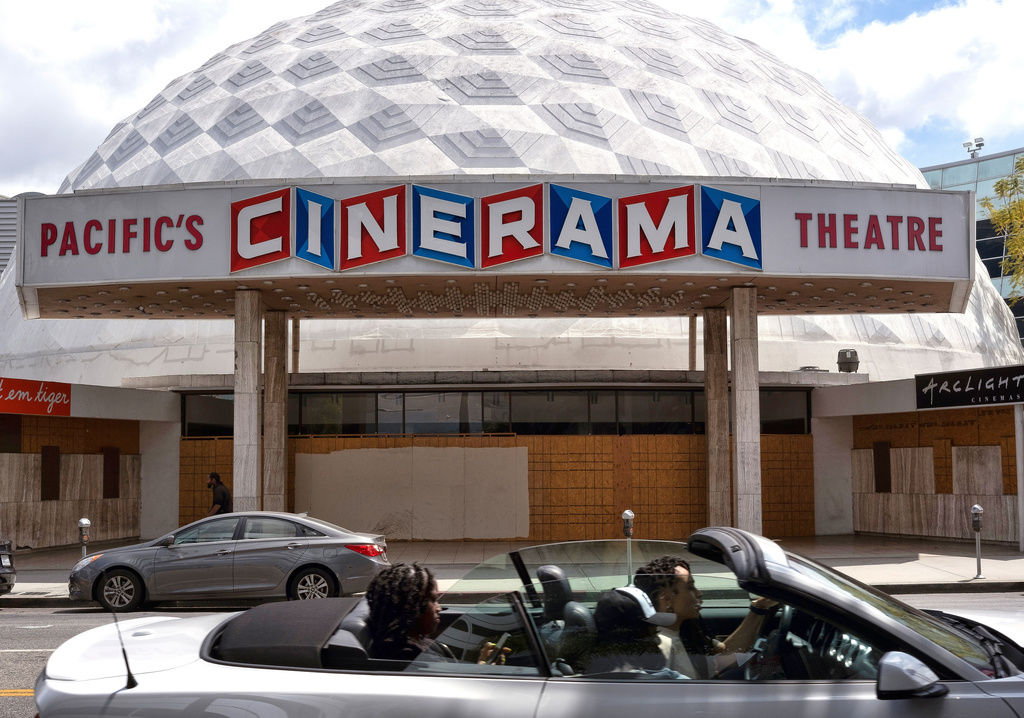 FILE - A motorist drives past the Cinerama Dome movie theater in Los Angeles on April 25, 2021. (AP Photo/Richard Vogel, File)