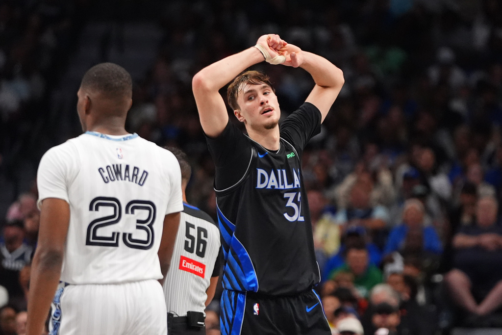 Dallas Mavericks forward Cooper Flagg, right, reacts to a play in front of Memphis Grizzlies forward Cedric Coward (23) during the second half of an NBA basketball game in Dallas, Saturday, Nov. 22, 2025. (AP Photo/LM Otero)