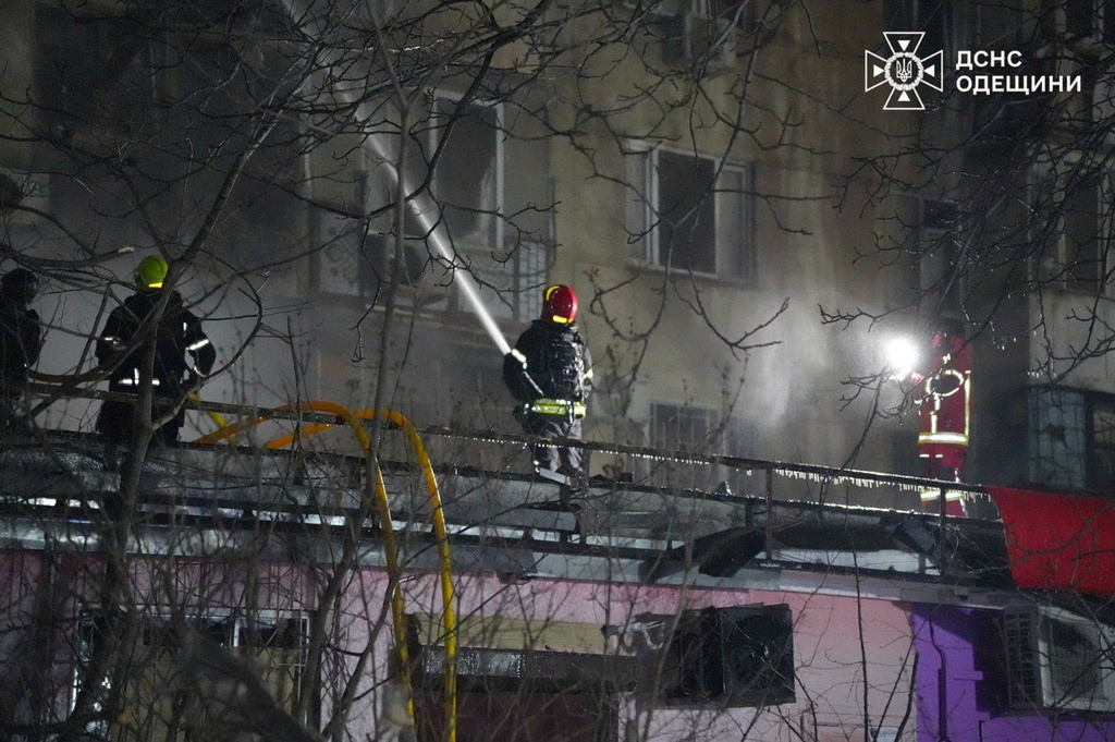 In this photo provided by the Ukrainian Emergency Service, emergency services personnel work to extinguish a fire following a Russian attack in Odesa, Ukraine, Wednesday, Dec. 31, 2025. (Ukrainian Emergency Service via AP)