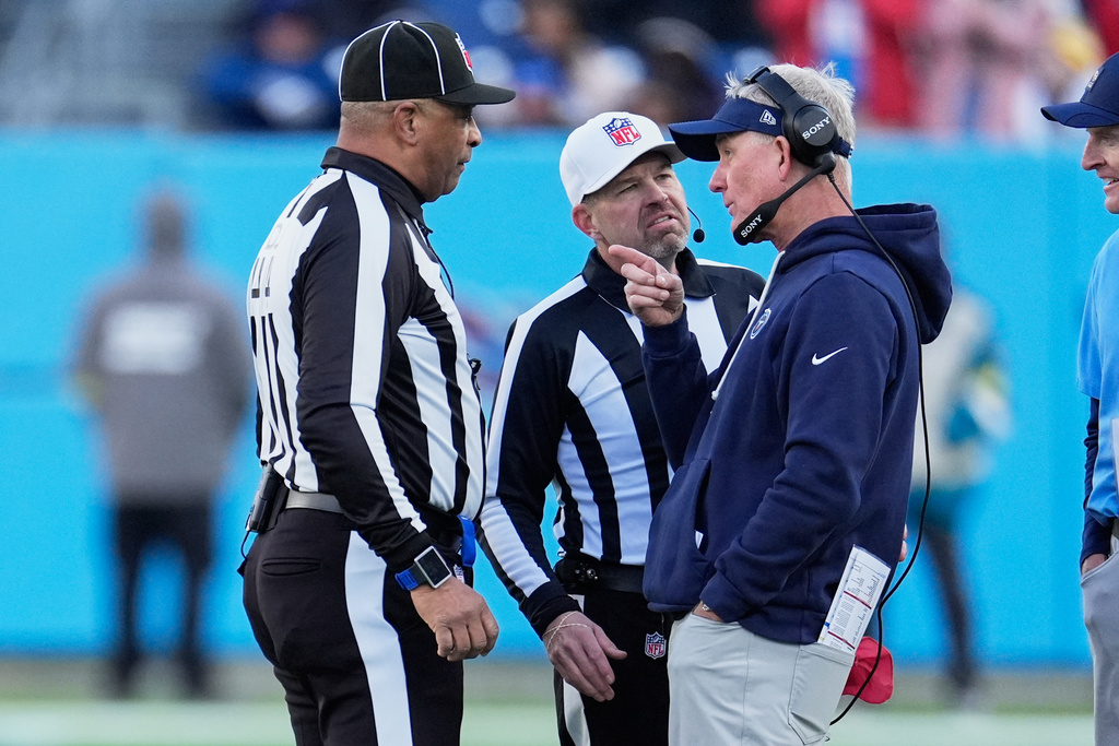 Tennessee Titans head coach Mike McCoy, right, has a discussion with officials during the second half of an NFL football game between the Tennessee Titans and the Jacksonville Jaguars Sunday, Nov. 30, 2025, in Nashville, Tenn. (AP Photo/George Walker IV)