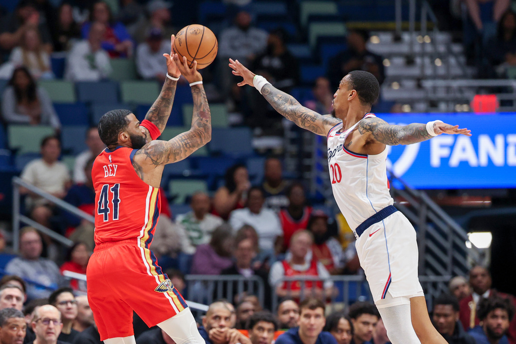 New Orleans Pelicans guard Saddiq Bey (41) shoots a three-pointer over Los Angeles Clippers forward John Collins (20) in the first half of an NBA basketball game in New Orleans, Thursday, March 19, 2026. (AP Photo/Peter Forest)